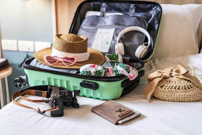 valise de vacances d'été ouverte avec chapeau et accessoires